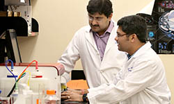 Dr. Shikhar Mehrotra works with a colleague in the lab